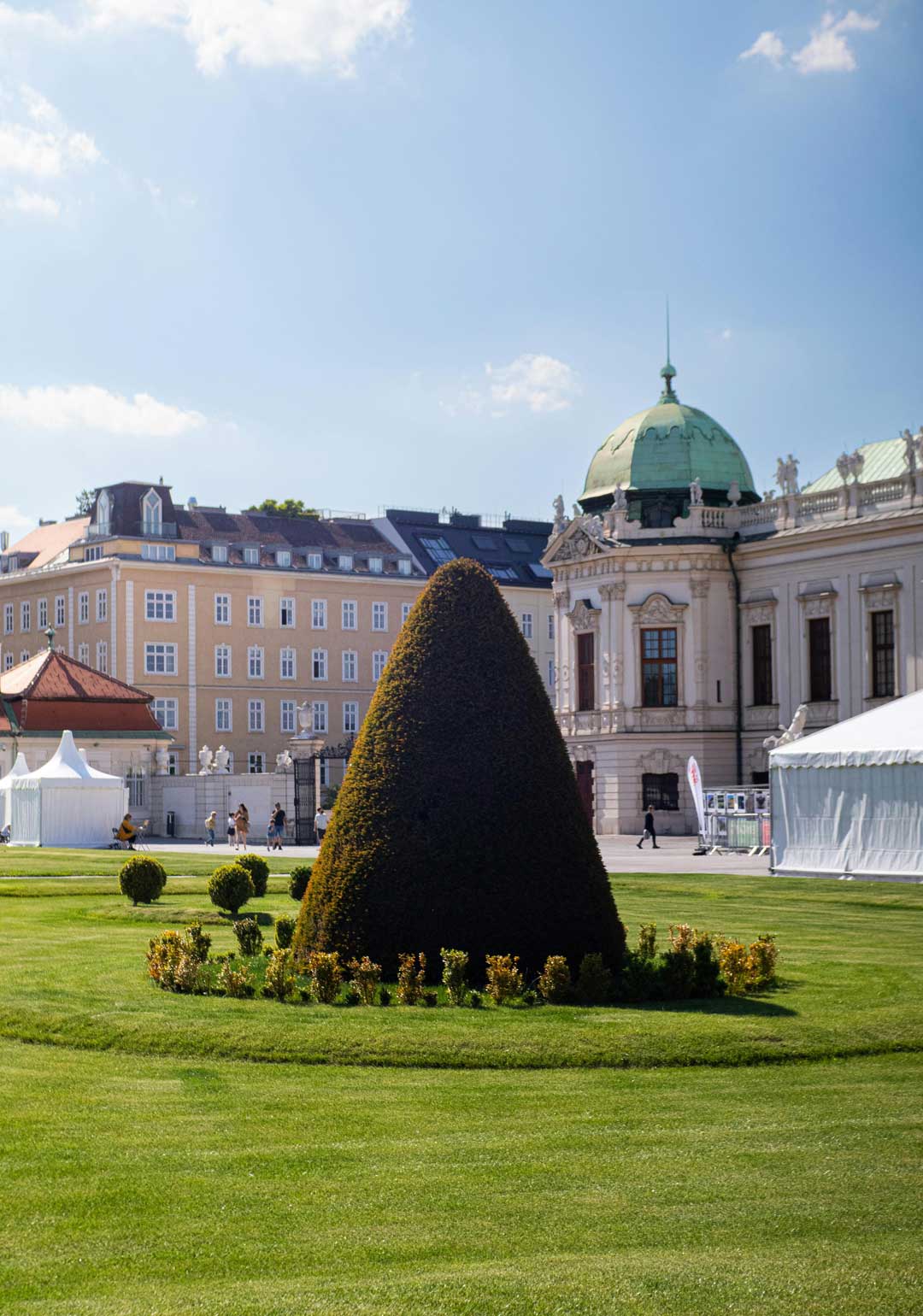 Side view of Belvedere Palace in Vienna; a green perfectly cut bush in front