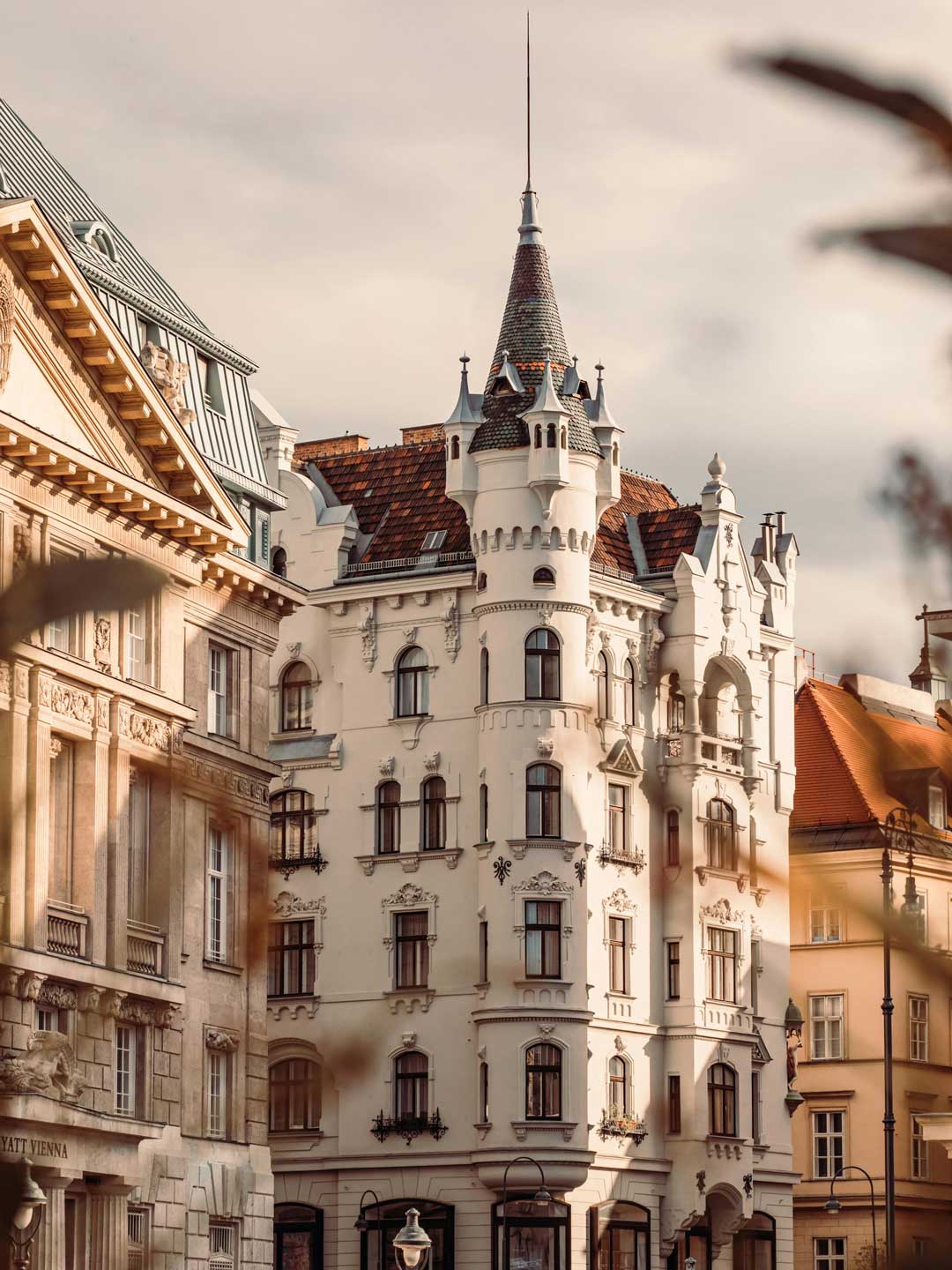 Big historic white buildung with a small tower that gives the house a castle like character - in Viennas 6th district - Mariahilf