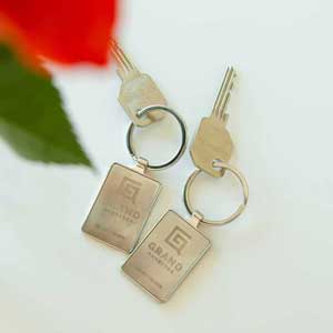 Two silver keys with Grand Quarters logo