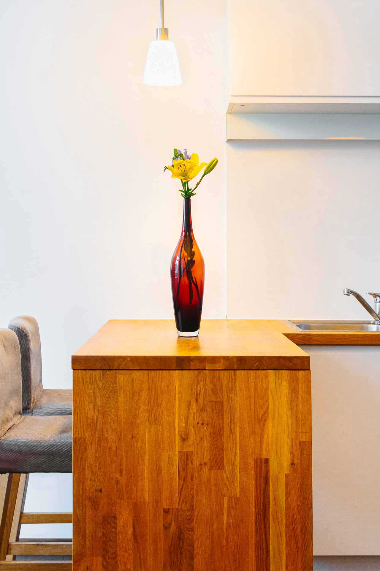 Wooden bar table with fresh flowers on top