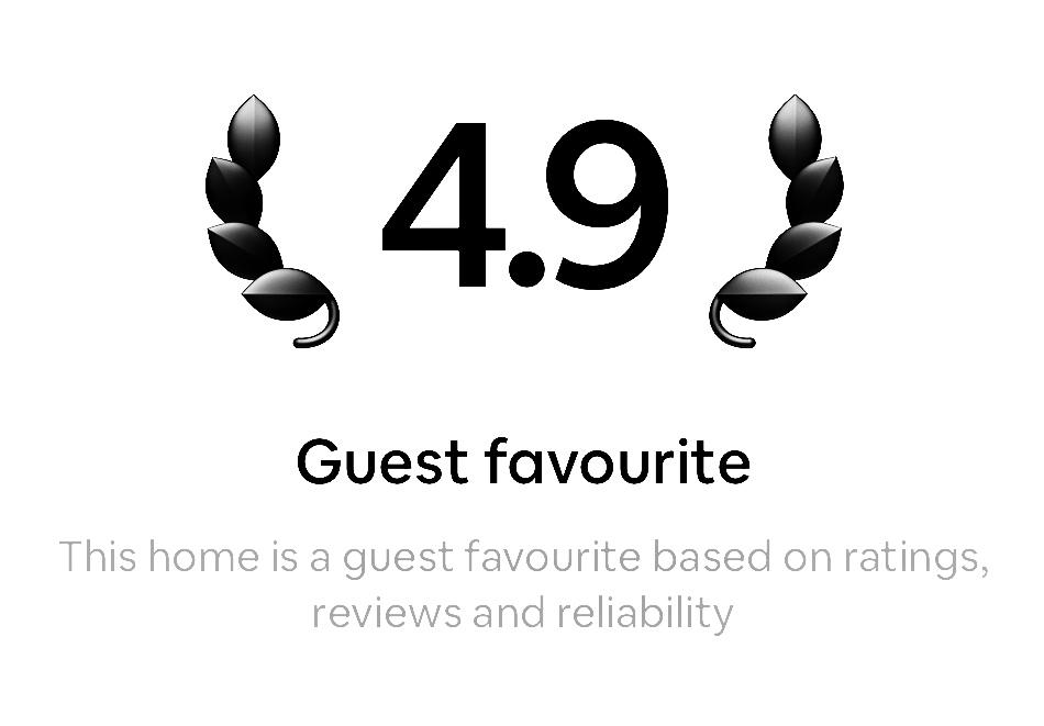 A picture of a guest favourite Airbnb sign with a 4.9 rating